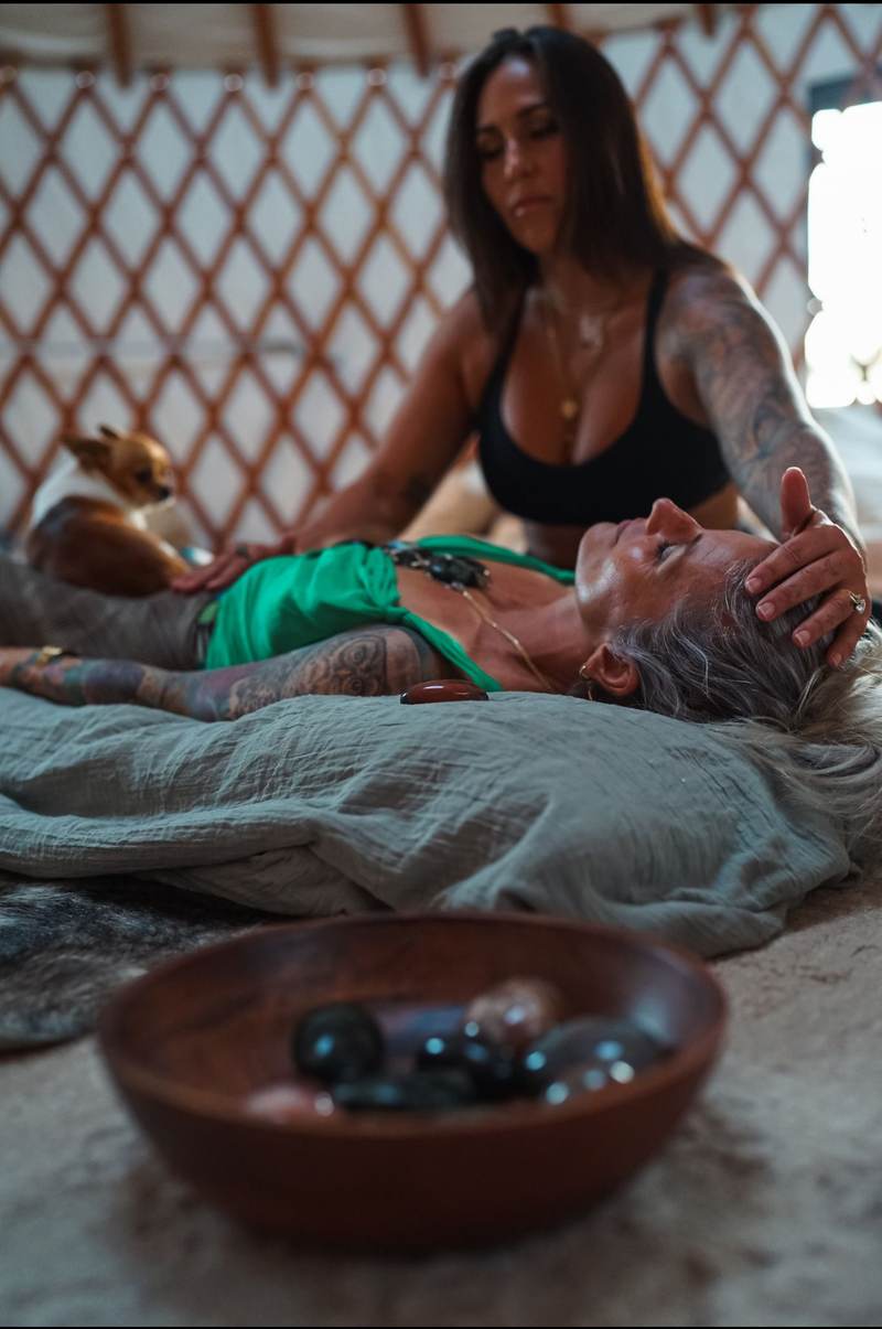 Reiki session with a bowl of crystals in the foreground